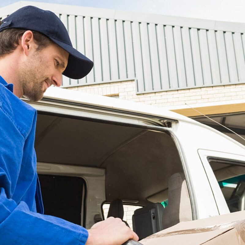 Delivery,Driver,Packing,His,Van,In,A,Large,Warehouse Delivery,Driver,Packing,His,Van,In,A,Large,Warehouse